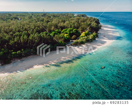 Tropical beach at island with trees and turquoise ocean. Aerial view. Paradise place 69283135