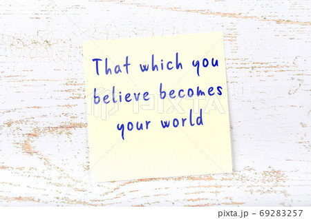 Yellow sticky note on wooden wall with wise quote 69283257