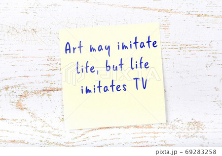 Yellow sticky note on wooden wall with wise quote 69283258