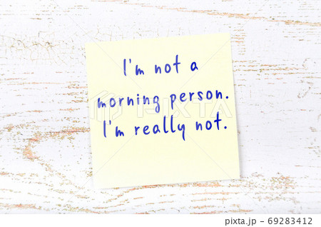 Yellow sticky note on wooden wall with wise quote Yellow sticky note on wooden wall with wise quote 69283412