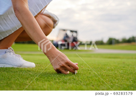 Lady Place Ball On Golf Pin . 69283579