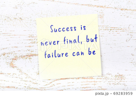 Yellow sticky note on wooden wall with wise quote 69283959