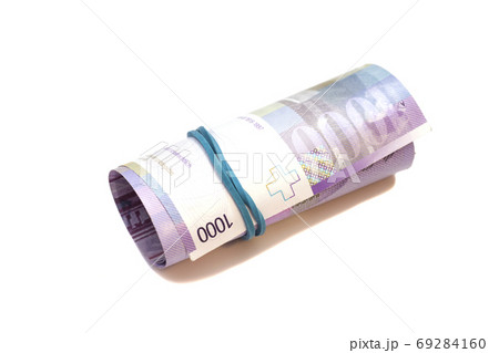 Swiss thousand francs in a roll on white background Swiss thousand francs in a roll on white background 69284160