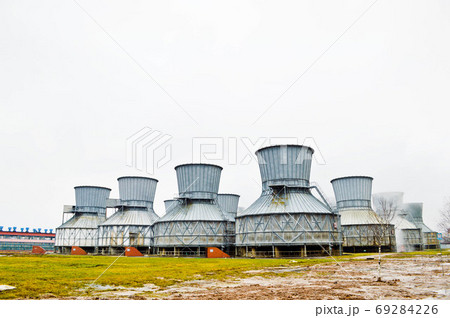Large cooling towers in water and fog at an oil 69284226