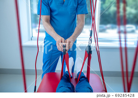 Male hands holding medical strap for physiotherapy Male hands holding medical strap for physiotherapy 69285428