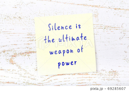 Wise quote on sticky note on wooden wall  69285607