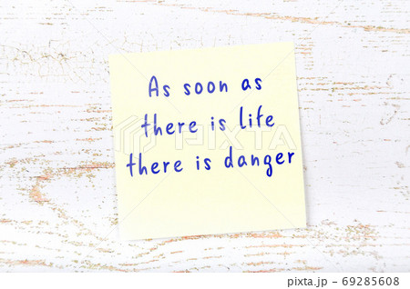 Wise quote on sticky note on wooden wall  69285608