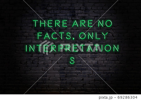 Wise quote. Neon inscription against brick wall 69286304