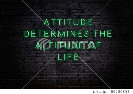Wise quote. Neon inscription against brick wall Wise quote. Neon inscription against brick wall 69286358