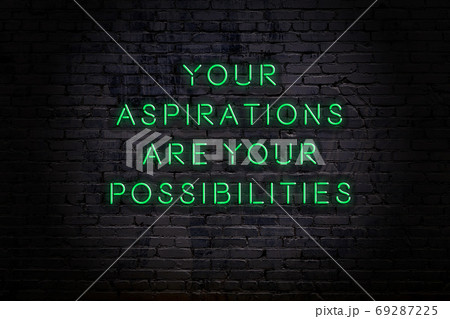Wise quote. Neon inscription against brick wall Wise quote. Neon inscription against brick wall 69287225