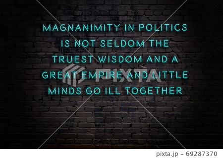 Wise quote. Neon inscription against brick wall Wise quote. Neon inscription against brick wall 69287370