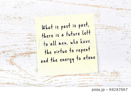 Yellow sticky note on wooden wall with wise quote 69287667