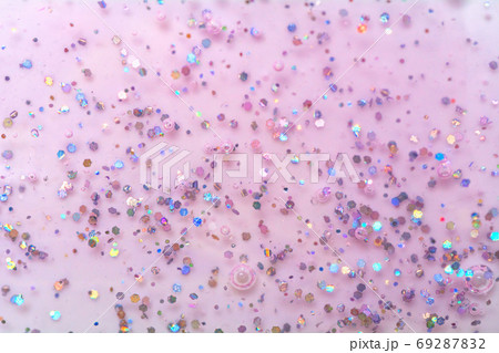 Texture of pink gel with sparkles. Glitter texture with sequins. Nail polish gel. Texture of pink gel with sparkles. Glitter texture with sequins. Nail polish gel. 69287832