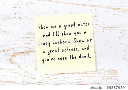 Yellow sticky note on wooden wall with wise quote Yellow sticky note on wooden wall with wise quote 69287939