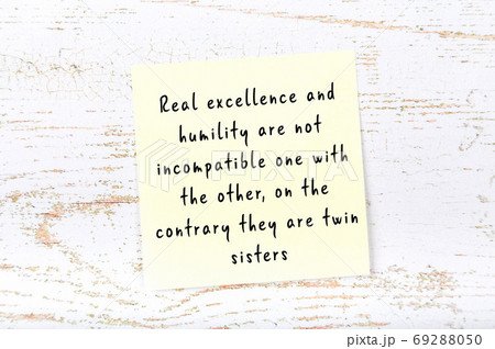 Yellow sticky note on wooden wall with wise quote Yellow sticky note on wooden wall with wise quote 69288050