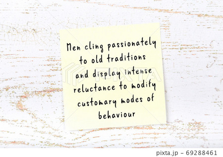 Yellow sticky note on wooden wall with wise quote 69288461
