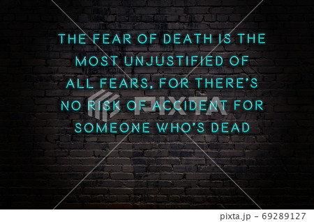 Wise quote. Neon inscription against brick wall Wise quote. Neon inscription against brick wall 69289127