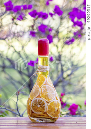 Pickled orange slices in glass bottle, on wooden table 69290517