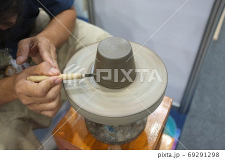 Concept Ceramic workshop. The man Throwing clay bowl on a pottery's wheel. Concept Ceramic workshop. The man Throwing clay bowl on a pottery's wheel. 69291298