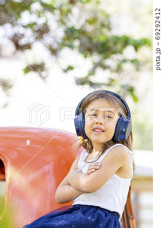 Little girl listening to music with her headphones in the truck 69292412