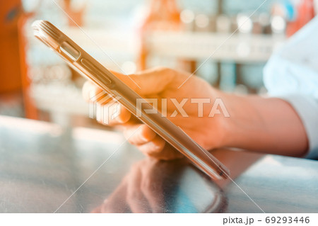 Closeup Image of Women Hand holding a smartphone Closeup Image of Women Hand holding a smartphone 69293446
