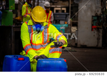 Engineer industry wearing safety uniform ,black gloves ,gas mask feel suffocate when under checking chemical tank in industry factory work Engineer industry wearing safety uniform ,black gloves ,gas mask feel suffocate when under checking chemical tank in industry factory work 69293630