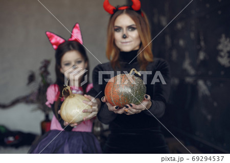 Mother with daughter in a halloween costume and makeup 69294537