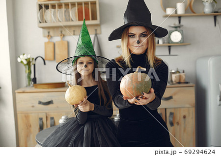 Mother with daughter in a halloween costume and makeup 69294624