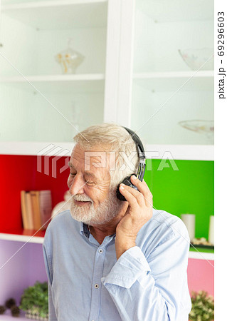 Senior retirement man listen to music using 69296603