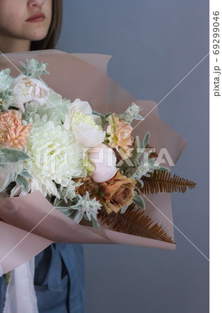Portrait of long-haired brunette girl with beautiful summer bouquet, gift or congratulation concept. Portrait of long-haired brunette girl with beautiful summer bouquet, gift or congratulation concept. 69299046