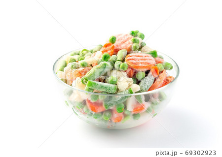 Glass bowl with frozen vegetables on white Glass bowl with frozen vegetables on white 69302923