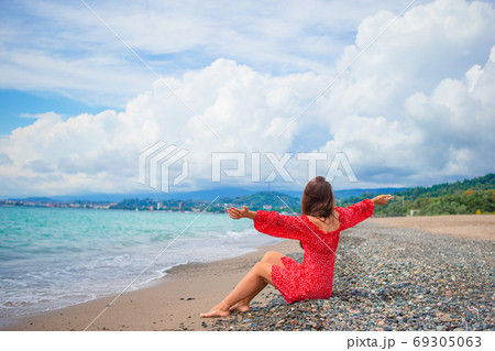 Young beautiful woman relax on the beach Young beautiful woman relax on the beach 69305063