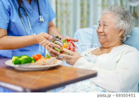Asian senior or elderly old lady woman patient eating breakfast 69305451