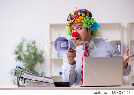 Funny employee clown working in the office Funny employee clown working in the office 69305478