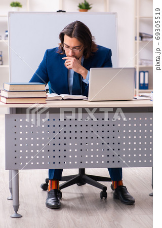 Young businessman student studying at workplace Young businessman student studying at workplace 69305519
