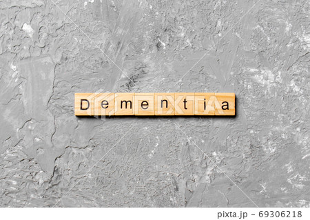 Dementia word written on wood block. Dementia text on cement table for your desing, concept Dementia word written on wood block. Dementia text on cement table for your desing, concept 69306218