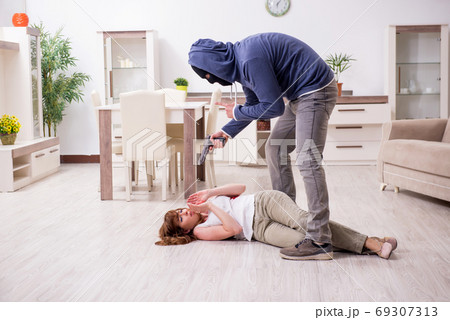 Gangster and young woman in robbery concept 69307313