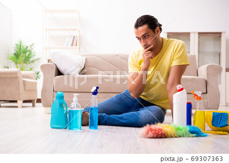 Young male contractor doing housework at home 69307363