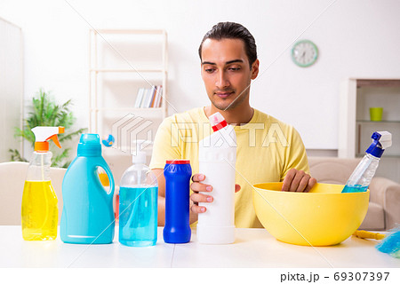 Young male contractor doing housework at home 69307397