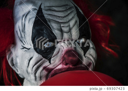 scary evil clown with a red balloon scary evil clown with a red balloon 69307423
