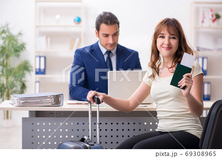 Young woman visiting embassy for visa 69308965