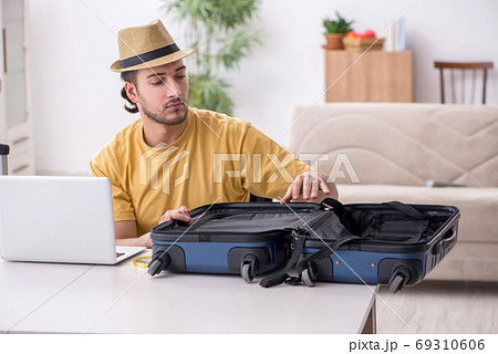 Young man preparing for journey at home 69310606