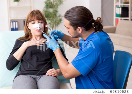 Young beautiful woman visiting doctor in plastic surgery concept Young beautiful woman visiting doctor in plastic surgery concept 69310628