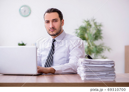 Young disabled employee suffering at workplace Young disabled employee suffering at workplace 69310700