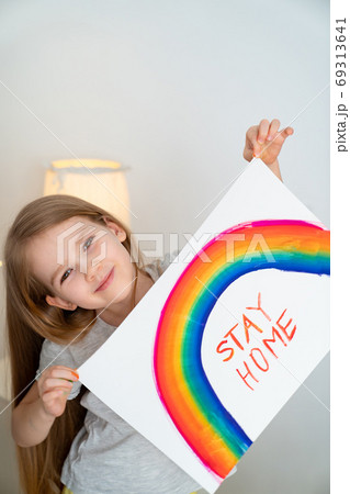 child girl drew rainbow and poster stay home. child girl drew rainbow and poster stay home. 69313641