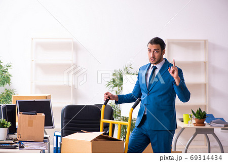 Young male employee in moving concept Young male employee in moving concept 69314434
