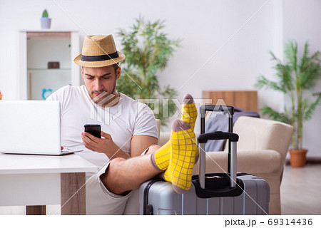 Young man preparing for departure at home Young man preparing for departure at home 69314436