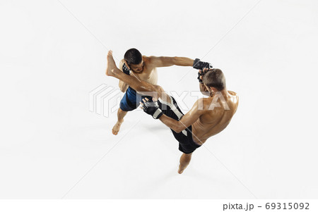 Two professional MMA fighters boxing isolated on white studio background, dynamic and motion. Top view 69315092