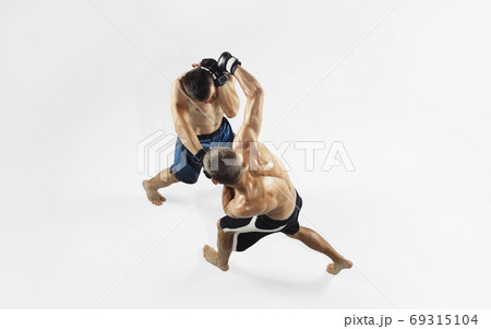 Two professional MMA fighters boxing isolated on white studio background, dynamic and motion. Top view Two professional MMA fighters boxing isolated on white studio background, dynamic and motion. Top view 69315104