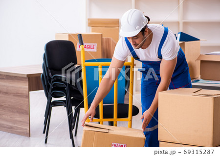 Young male professional mover doing home relocation Young male professional mover doing home relocation 69315287